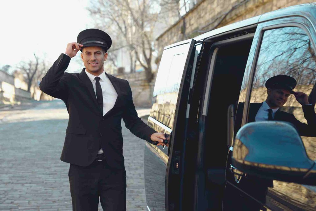 A man in a suit and tie exits a black limousine, exuding professionalism and elegance.